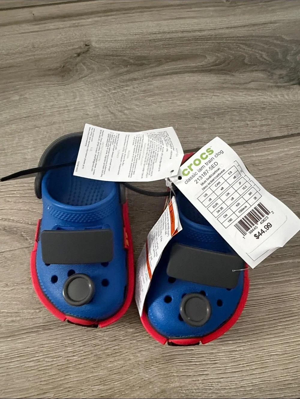 CROCS Kids Clog in Blue with Red Trim and Black Badges